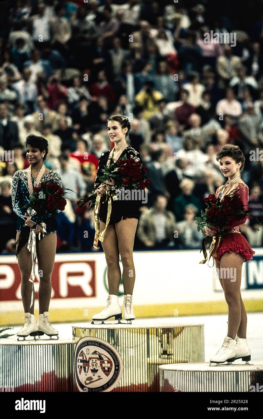 Katerina Witt (GDR) -C- wins the gold medal, with Debi Thomas (USA) -L- silver, and  Caryn Kadavy (USA) -R-bronze at the 1987 World Figure Skating Championships. Stock Photo