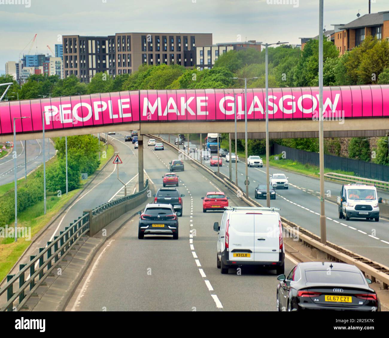 Glasgow, Scotland, UK 17th May, 2023. UK Weather: Warm  in the city centre saw locals take to the streets to enjoy city life. Trafficon the clydeside expressway treated to council propaganda.   Credit Gerard Ferry/Alamy Live News Stock Photo