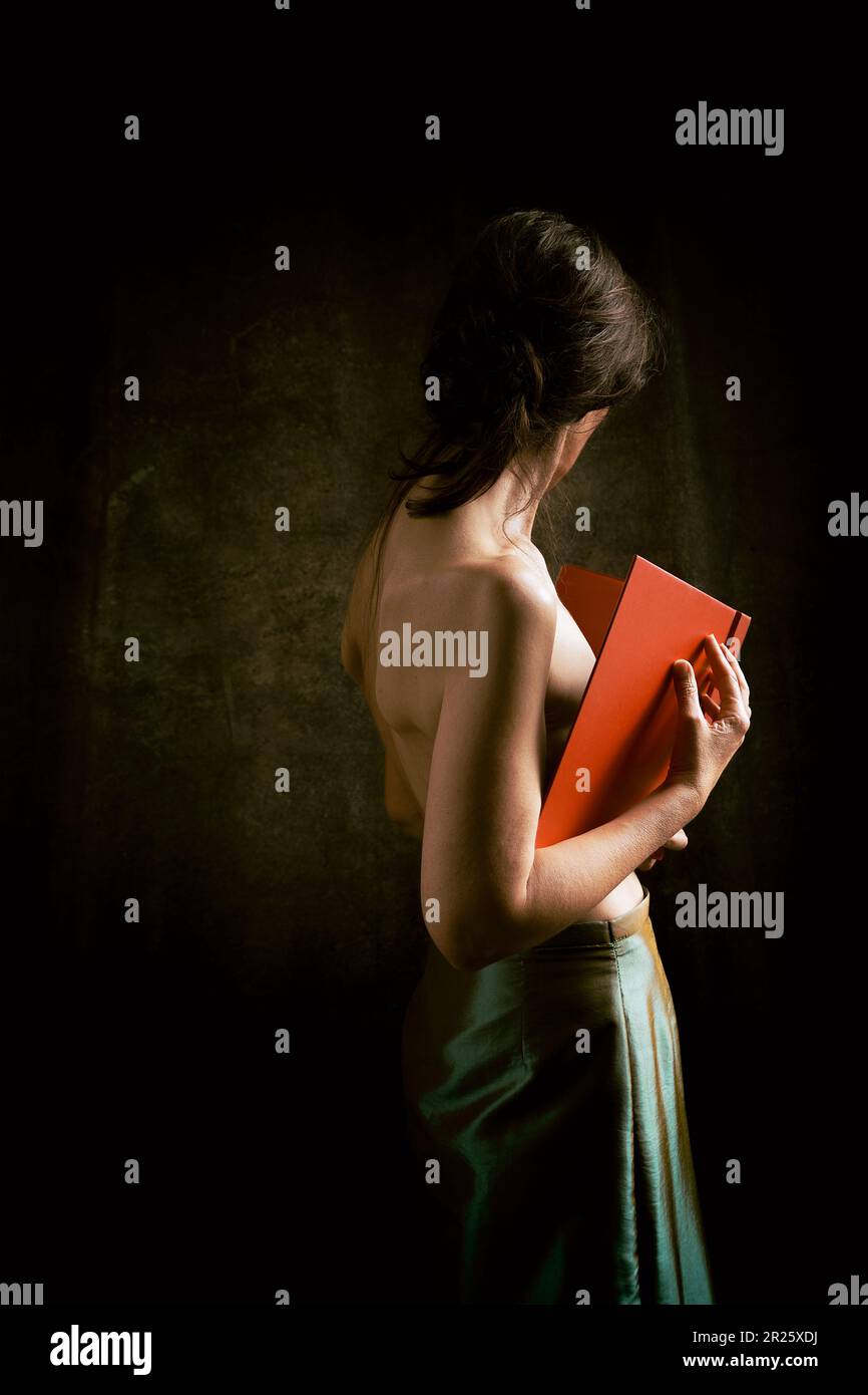 woman in green skirt reading a book in romantic attitude Stock Photo Alamy