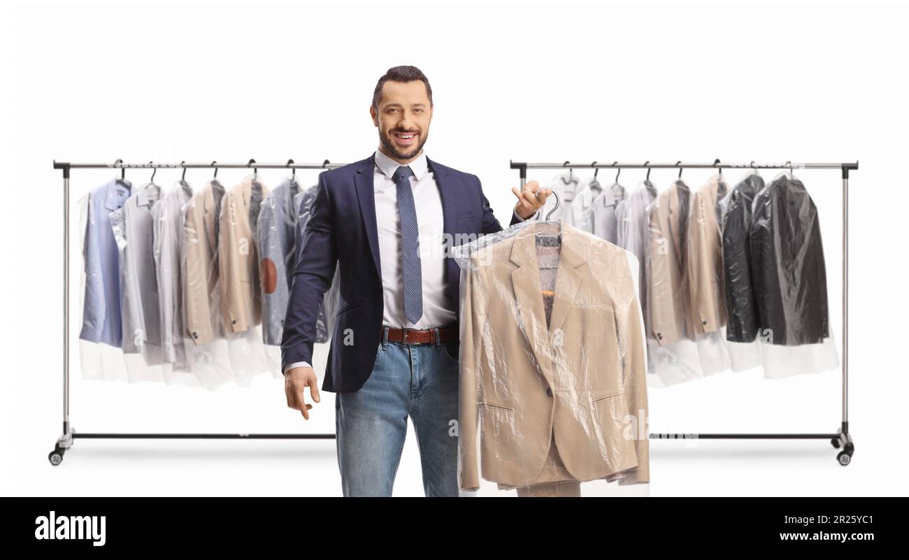 Man in front of clothing racks collecting a suit from dry cleaners isolated on a white background Stock Photo