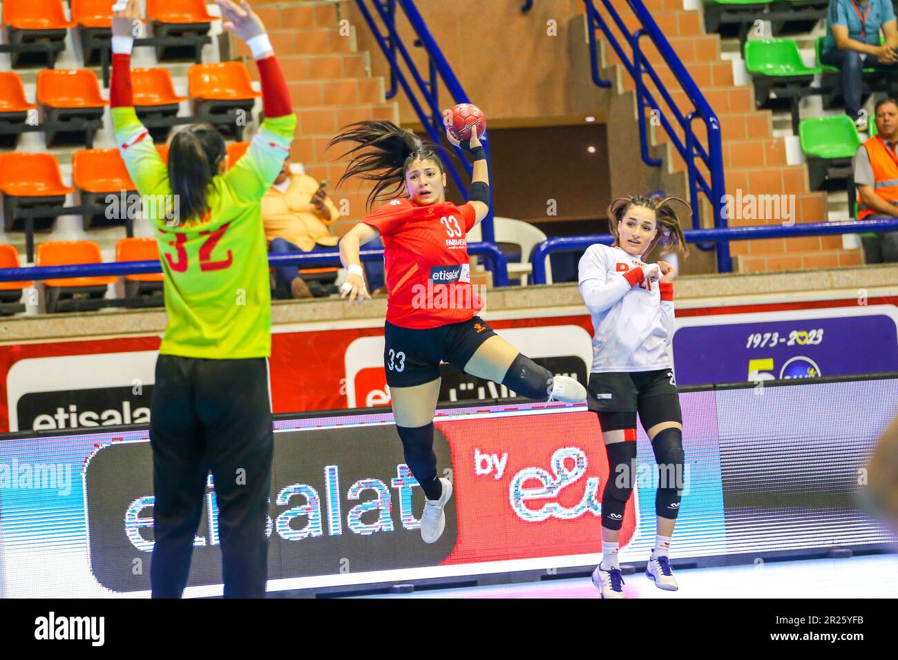 Amina Atef Haggag of Al Ahly and Moknine defenders during the 2023 women African Handball confederation match between Al Ahly Dames and Moknine of Tunisia in Cairo, Egypt. Stock Photo