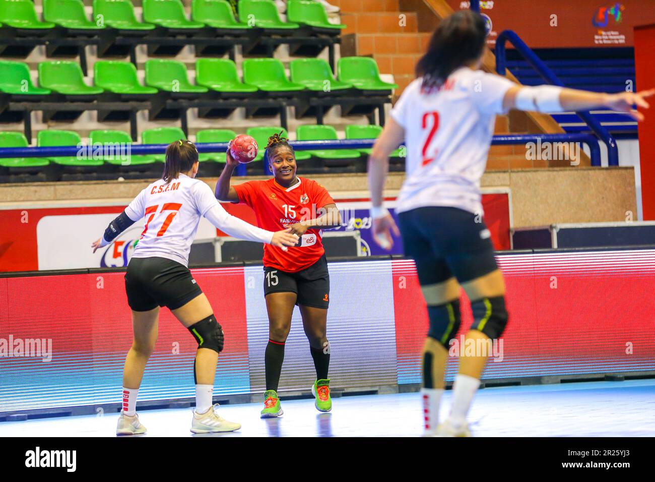 Dongou Camara of Al Ahly and Moknine defenders during the 2023 women African Handball confederation match between Al Ahly Dames and Moknine of Tunisia in Cairo, Egypt. Stock Photo
