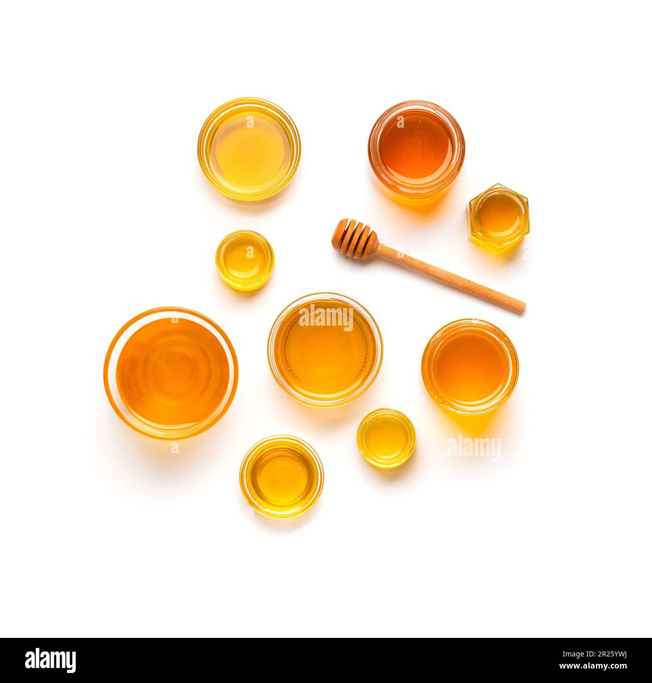Creative composition of honey jars and wooden dipper on isolation top view. Honey in a glass