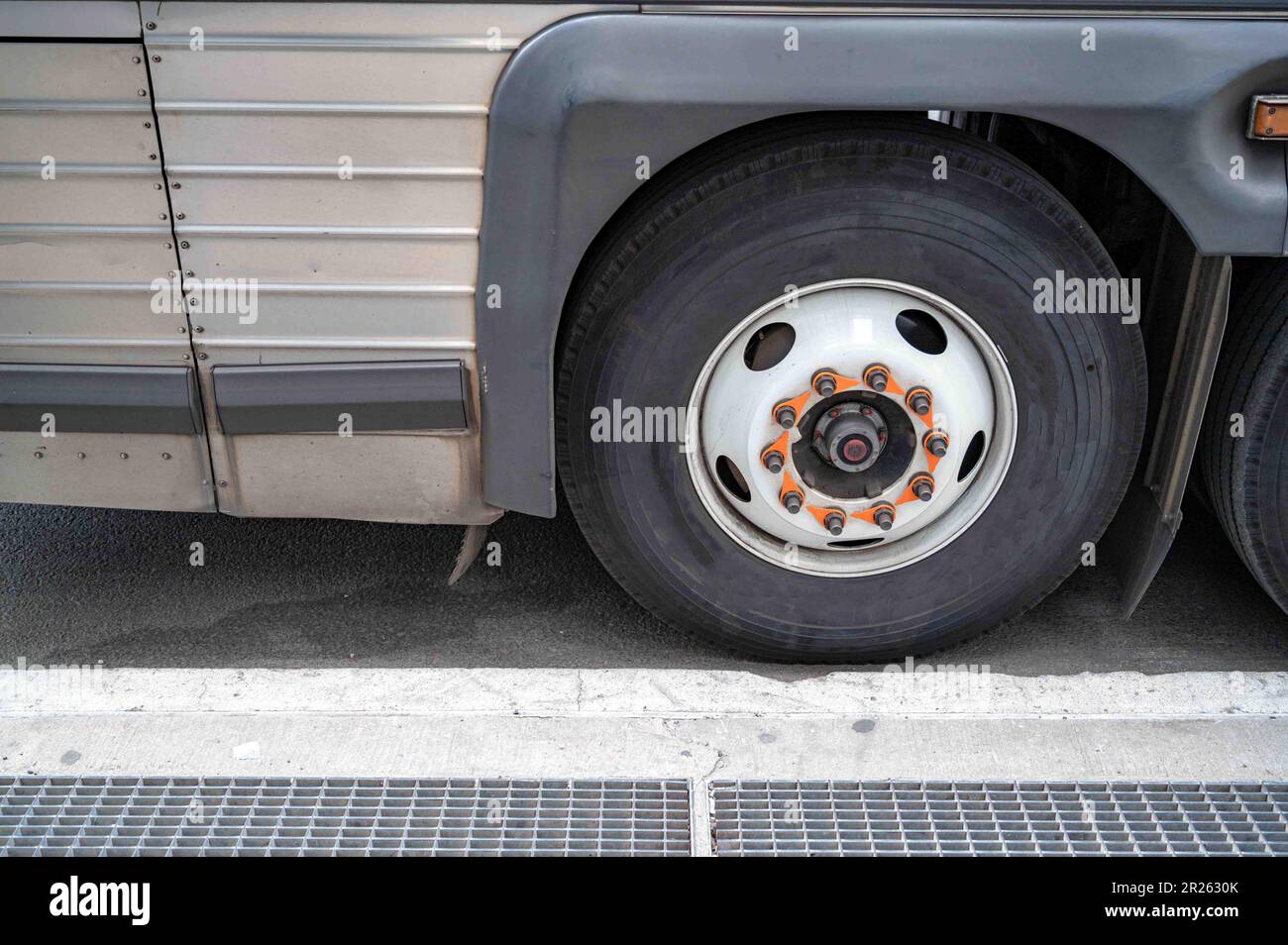 Closeup of city public transportation commuter bus wheel on street Stock Photo