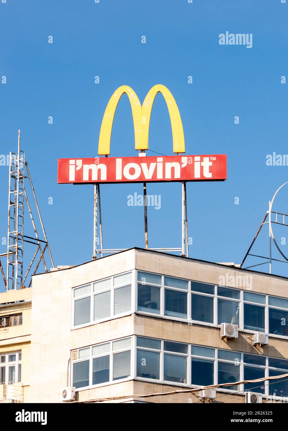 McDonald's I'm Lovin' It logo sign slogan advertising on building roof in Sofia, Bulgaria, Eastern Europe, Balkans, EU Stock Photo