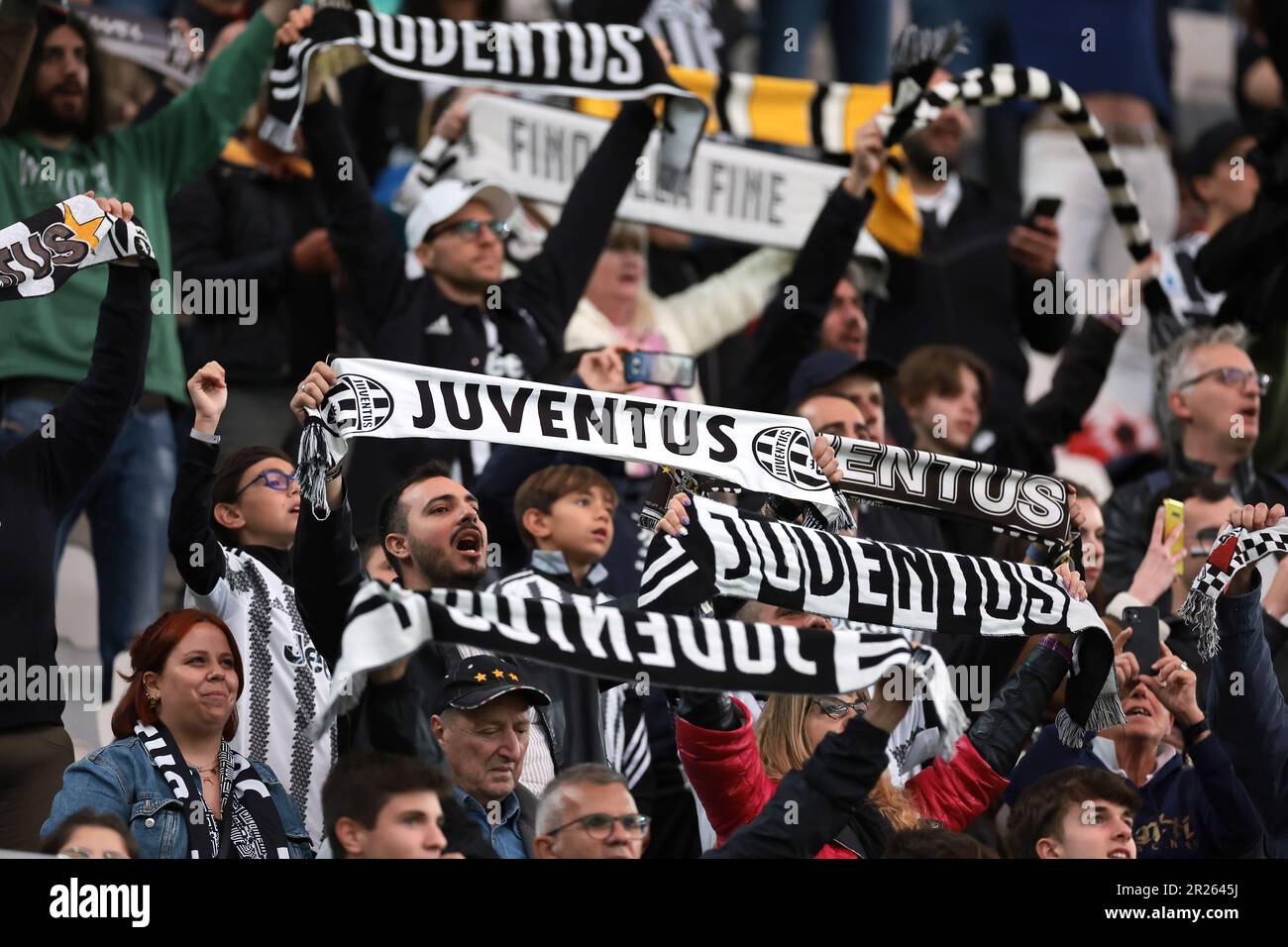 Turin, Italy, 14th May 2023. Juventus fans hold up scarves as the club's  song is played prior to kick off in the Serie A match at Allianz Stadium,  Turin. Picture credit should