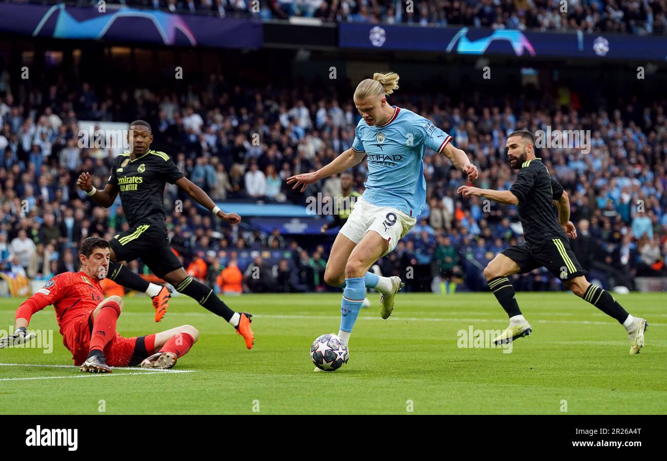 Manchester City's Erling Haaland rounds Real Madrid goalkeeper Thibaut ...