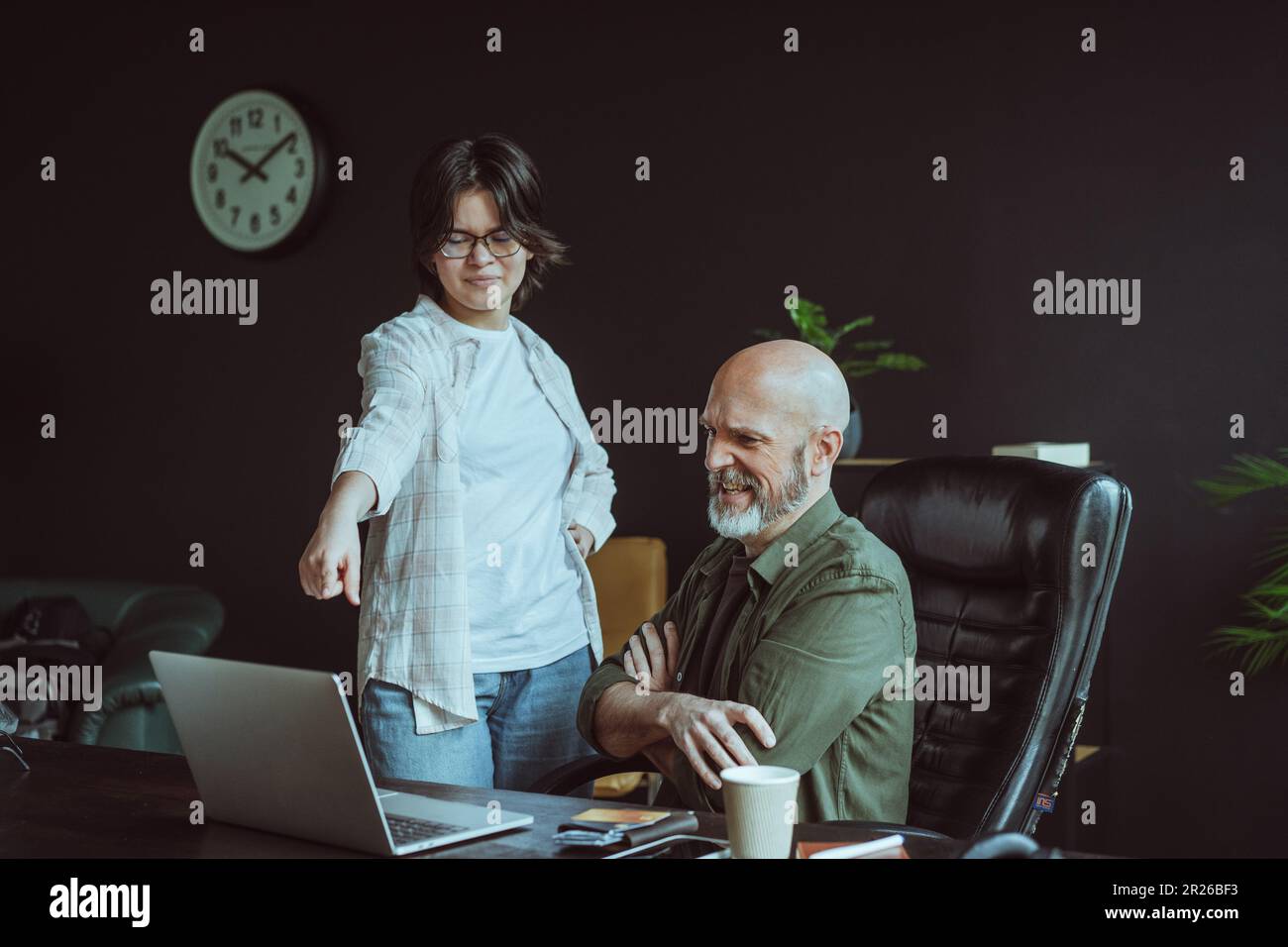 Father refusing buy online goods for daughter, specifically in context of controlling her choice of wear. Father-daughter relationship, highlighting clash of opinions and decision-making processes. . High quality photo Stock Photo