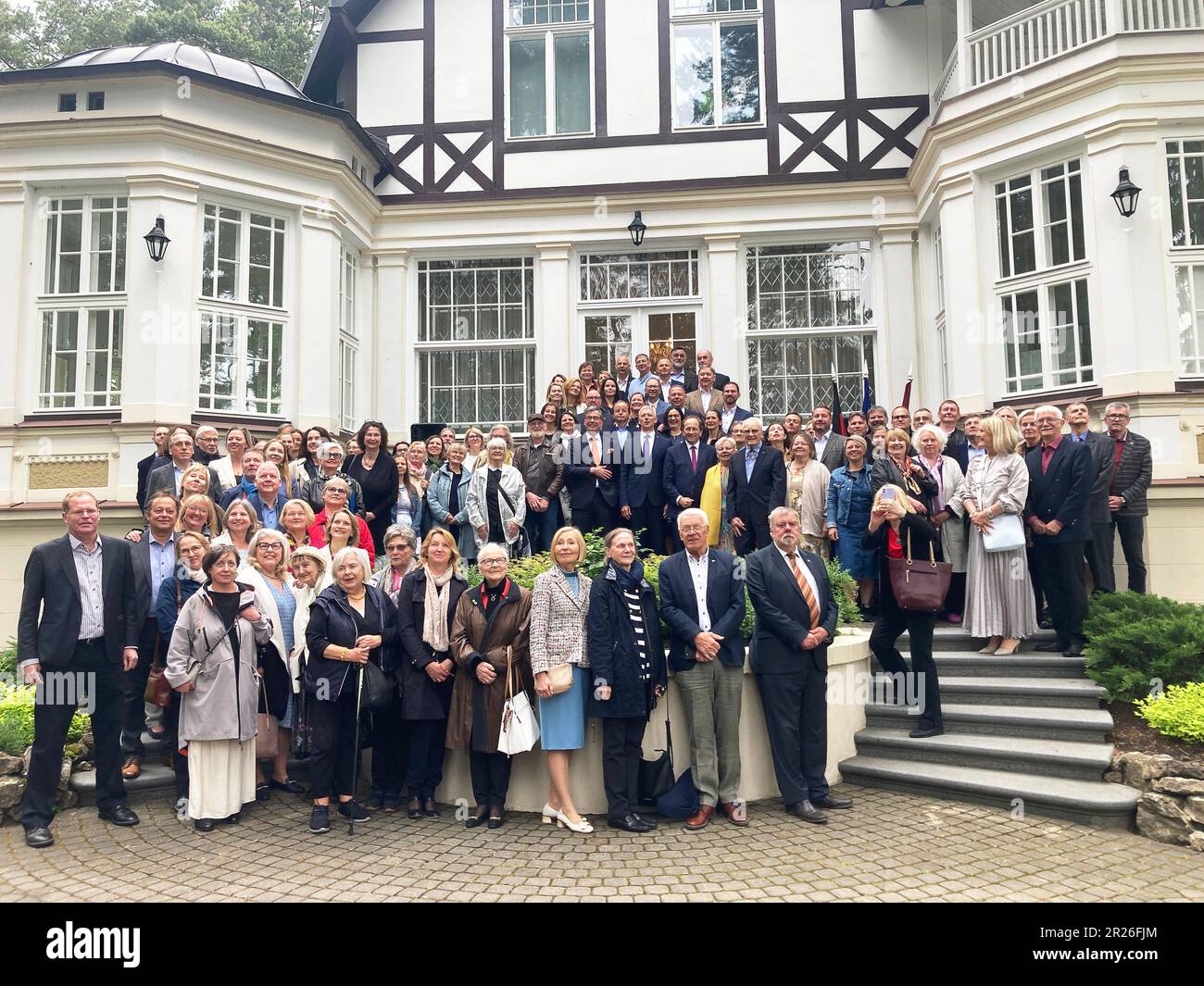 Riga, Latvia. 17th May, 2023. Former students, teachers and friends of the Latvian Gynasium in Münster stand together for a group photo. Credit: Alexander Welscher/dpa/Alamy Live News Stock Photo