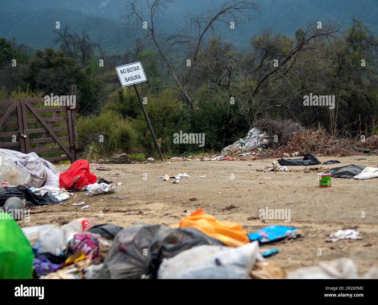 Fly tipping rubbish dumped in the countryside near prohibitory sign in ...