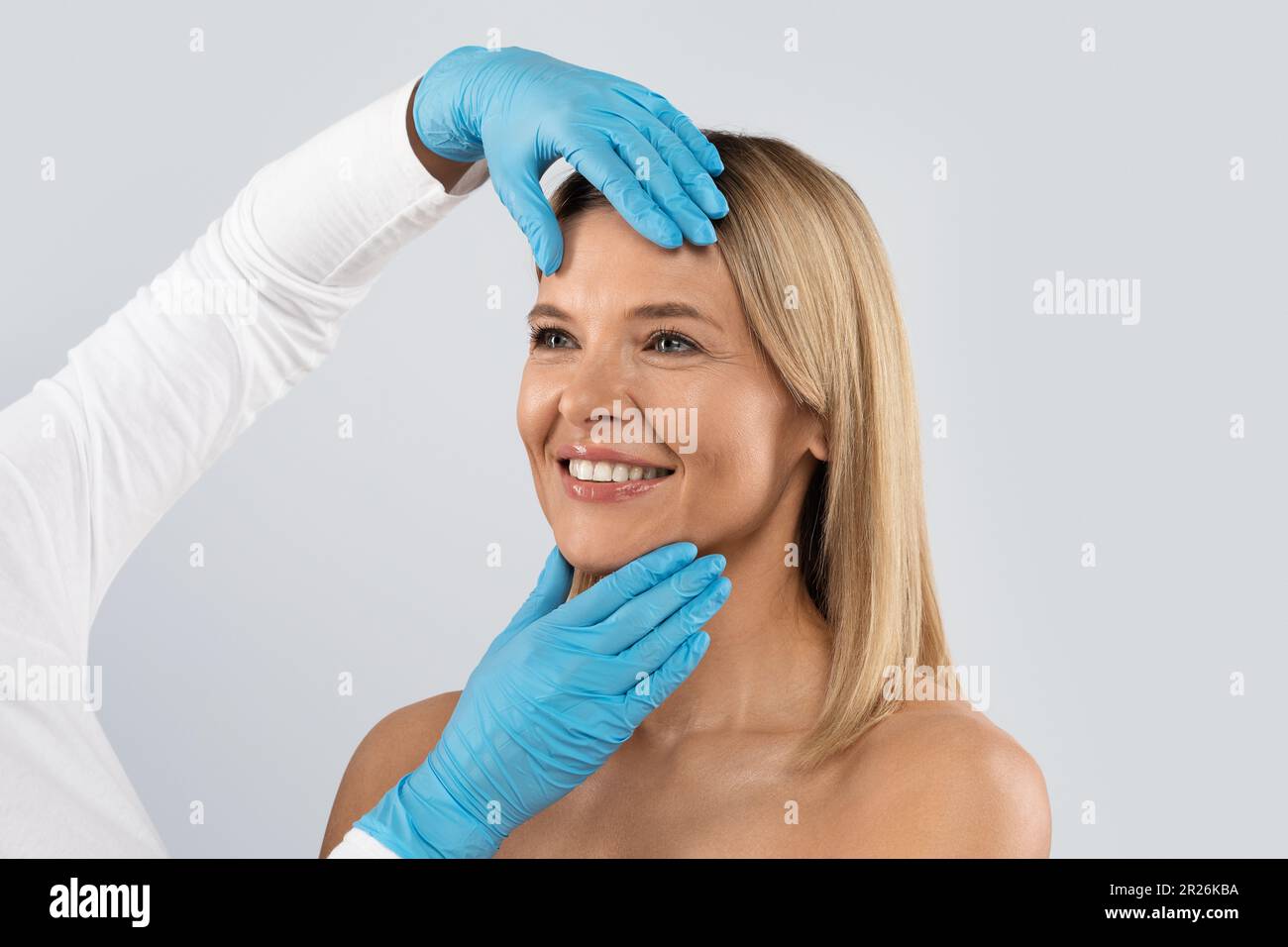 Plastic Surgeon Doctor Touching Middle Aged Woman Face Stock Photo Alamy