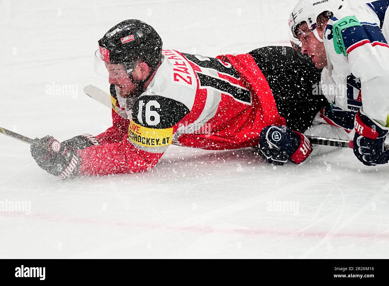 Austrias Dominic Zwerger, left, and United States Carter Mazur battle for the puck during the group A match between United States and Austria at the ice hockey world championship in Tampere, Finland,