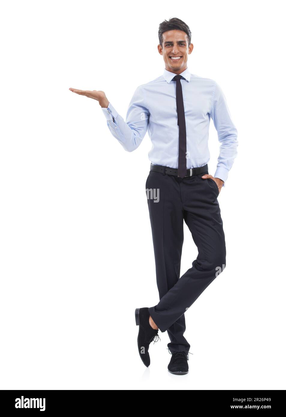The secret to his success. Portrait of a handsome young businessman standing with one hand outstretched against a white background. Stock Photo