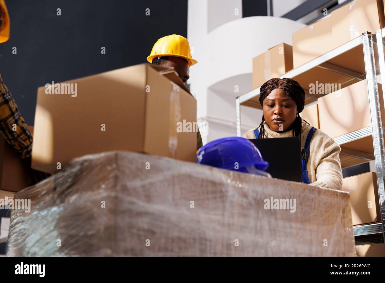 Package handlers picking order and packing parcel in warehouse Stock