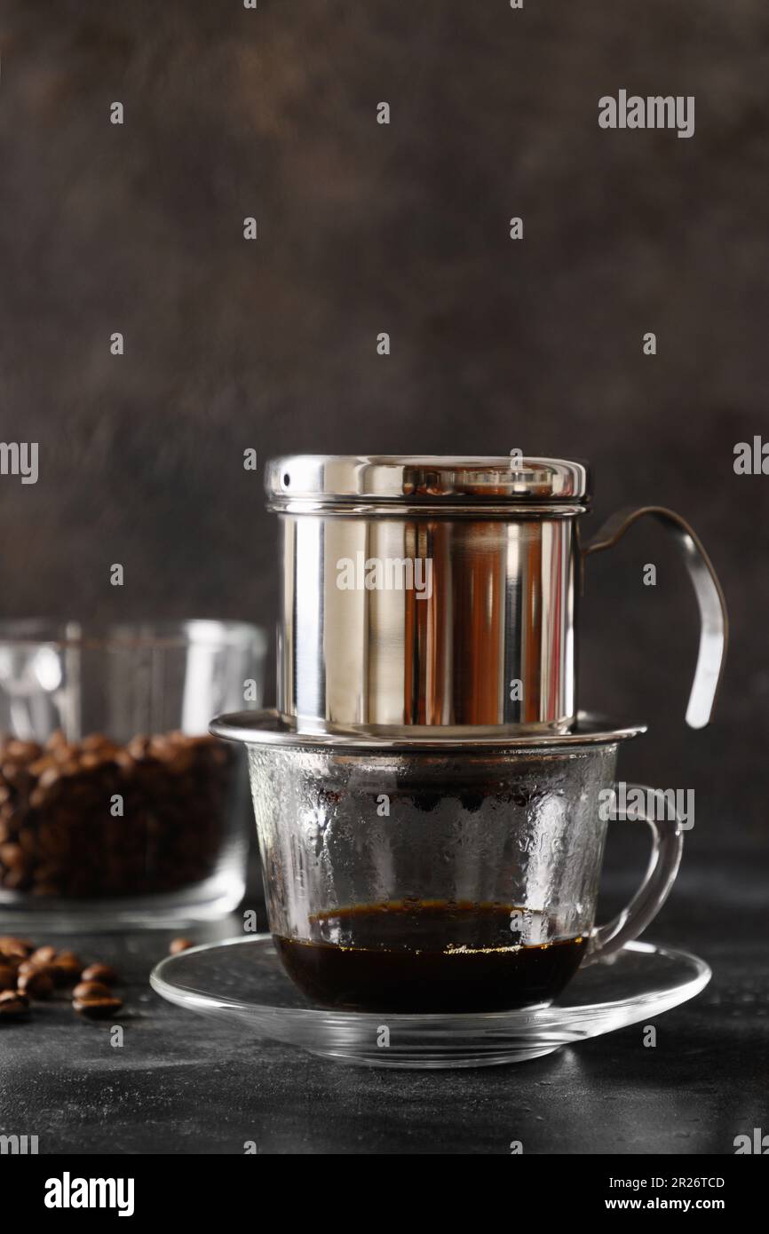 https://c8.alamy.com/comp/2R26TCD/traditional-method-of-making-vietnamese-coffee-with-condensed-milk-on-black-background-close-up-vertical-format-2R26TCD.jpg