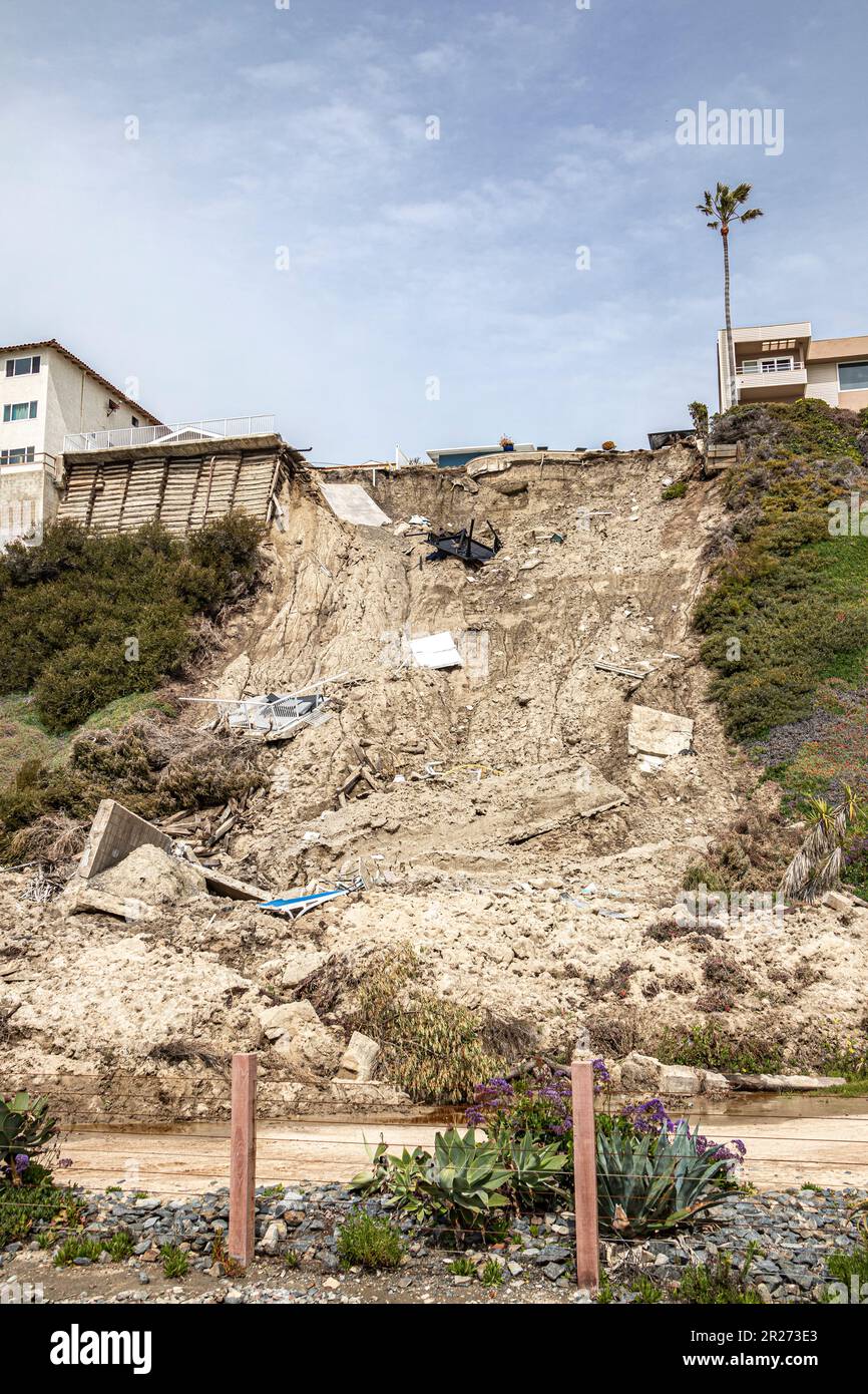 Landslide of cliff after major storm in residential area of San Clemente. Homes and swimming pools balance precariously at edge of cliff overlooking b Stock Photo