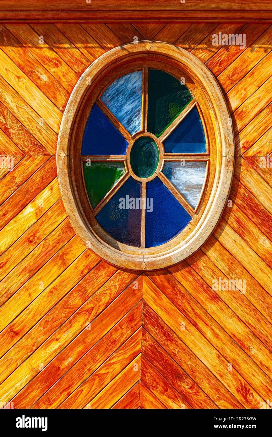 Round window at wooden wall . Window with colorful glass Stock Photo Alamy