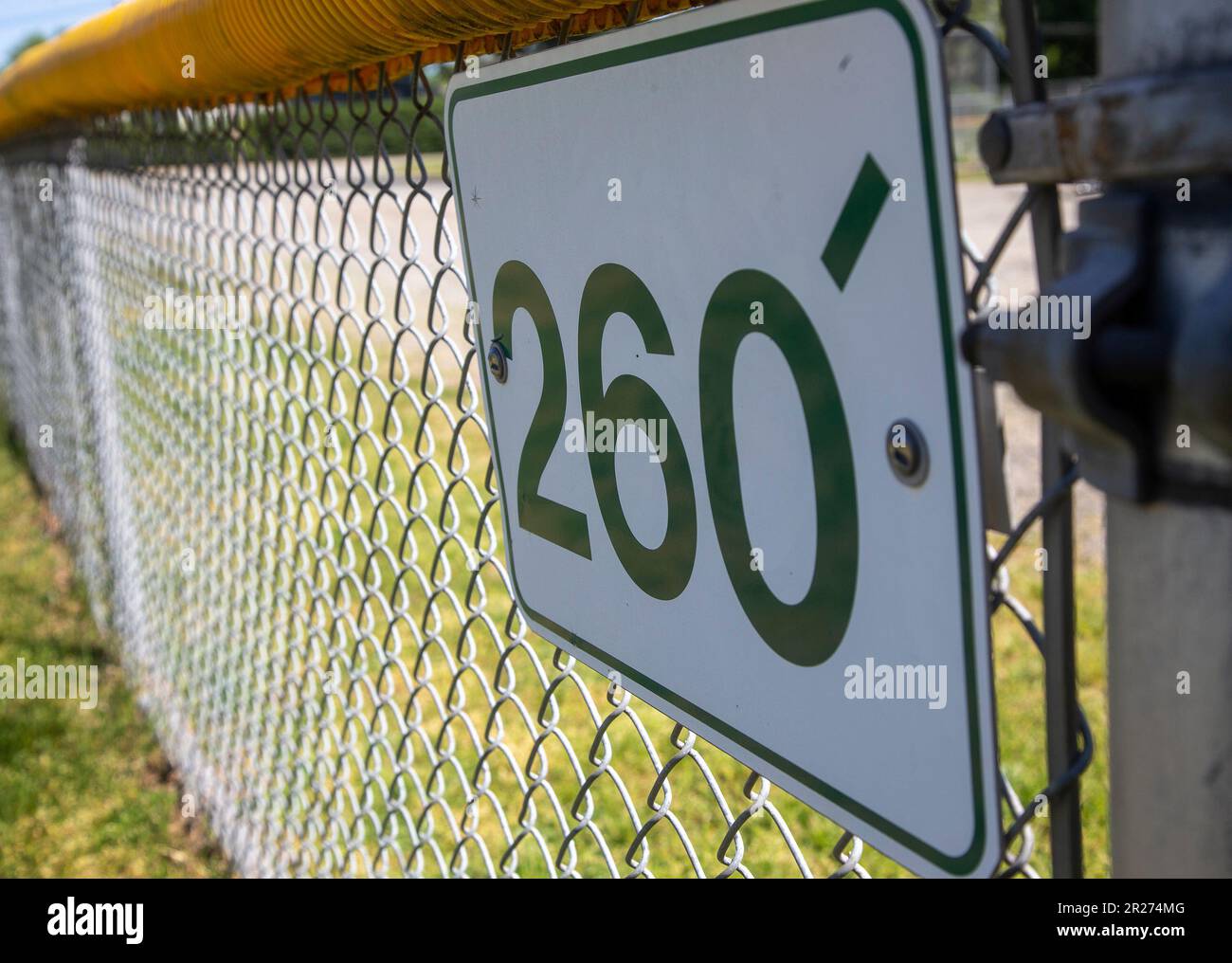 Sign showing distance to fence from home plate at a baseball field Stock Photo