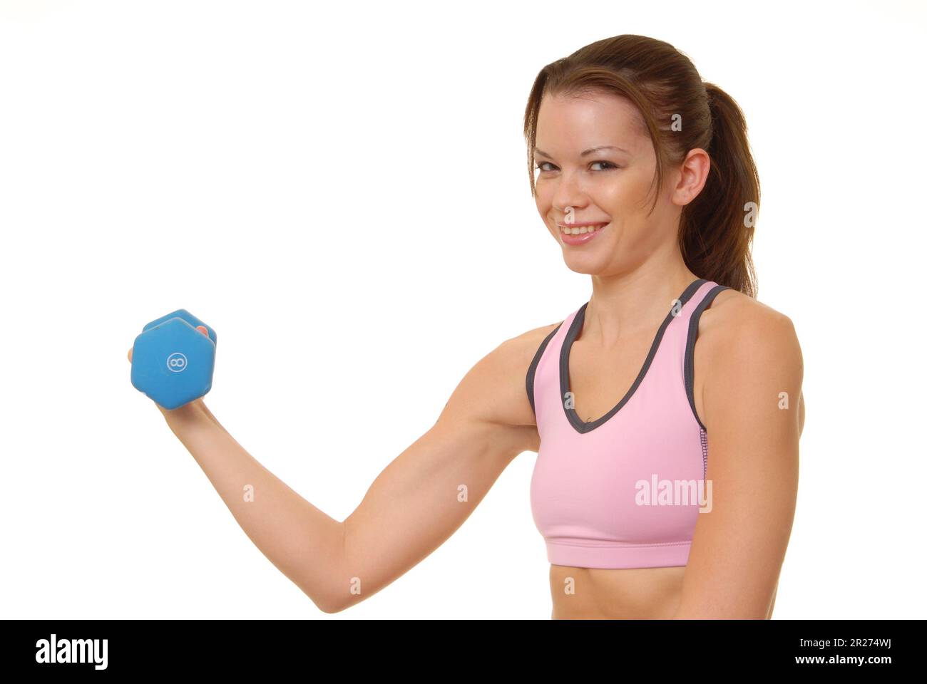 Lovely young brunette lady lifting a dumbbell Stock Photo