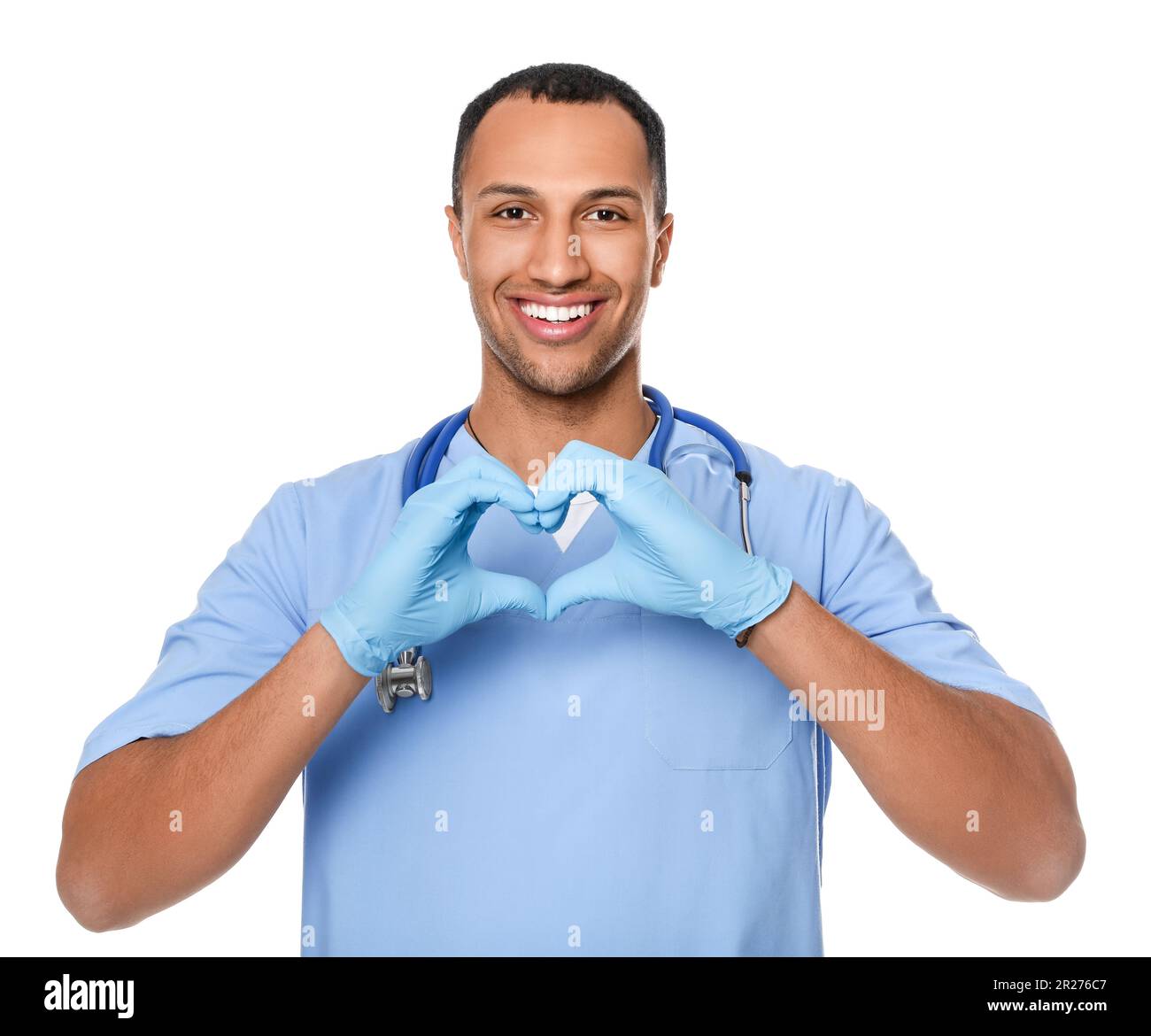 Doctor or medical assistant (male nurse) making heart with hands on ...