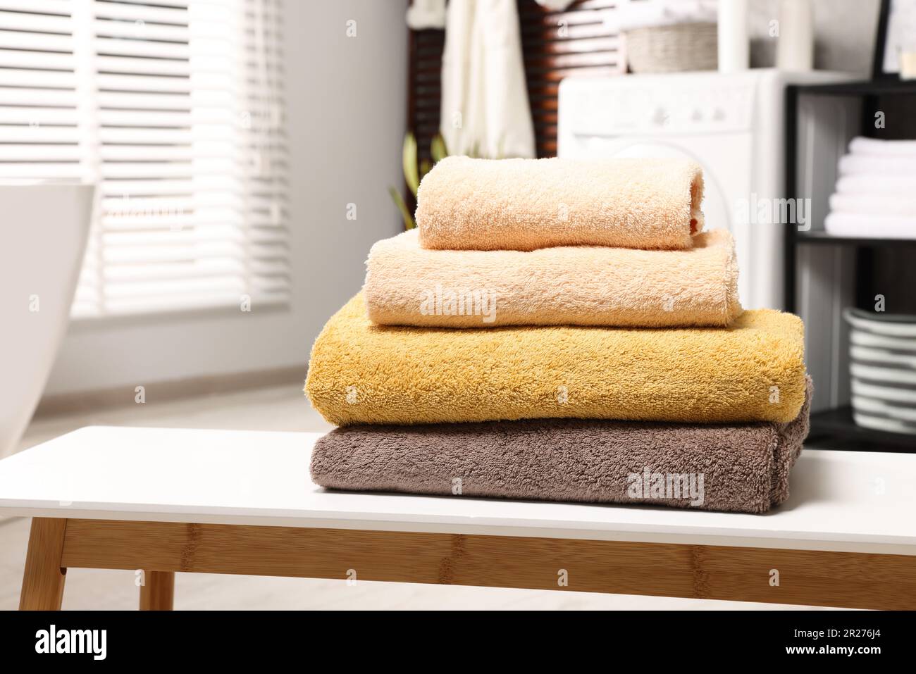 Stack of clean towels on white table in laundry room, space for text Stock  Photo - Alamy