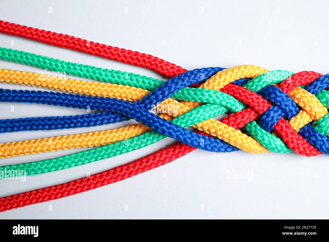 Braided colorful ropes isolated on white, top view. Unity concept Stock ...