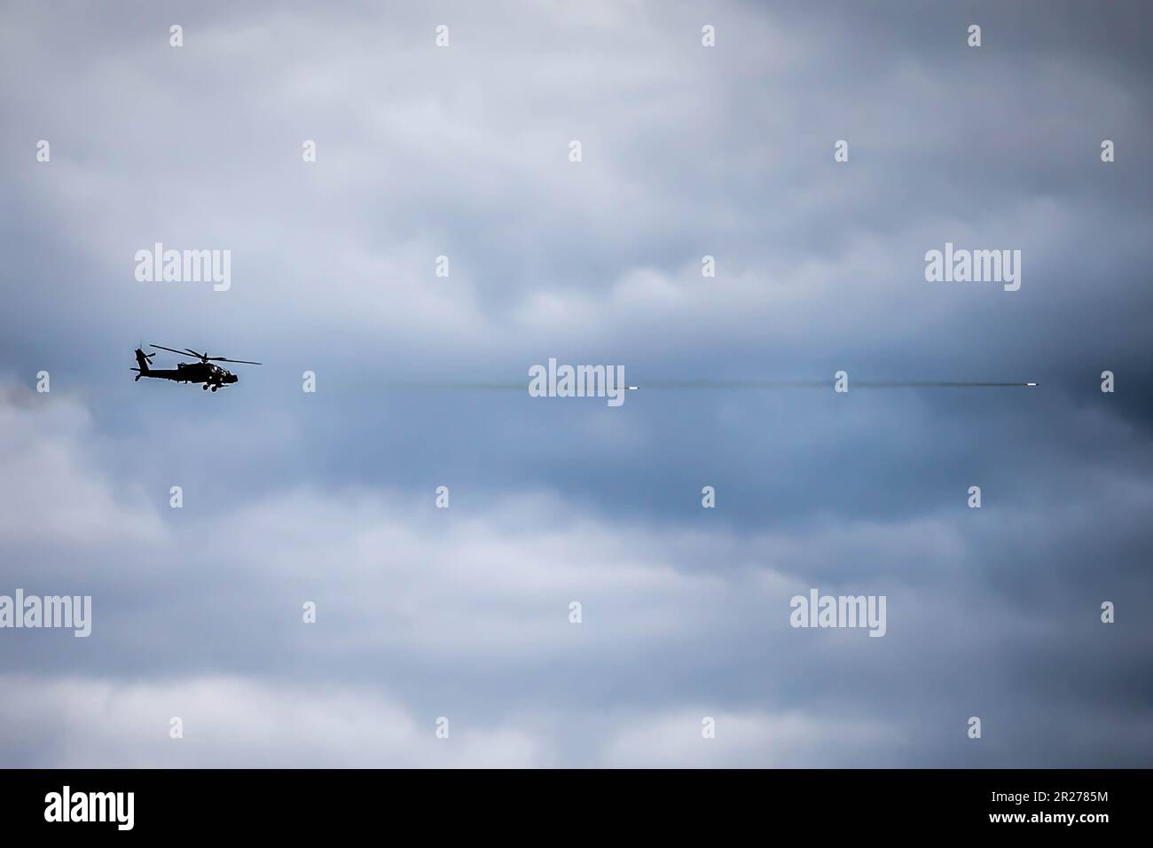 An AH-64D Apache helicopter engages enemy targets during a combined ...