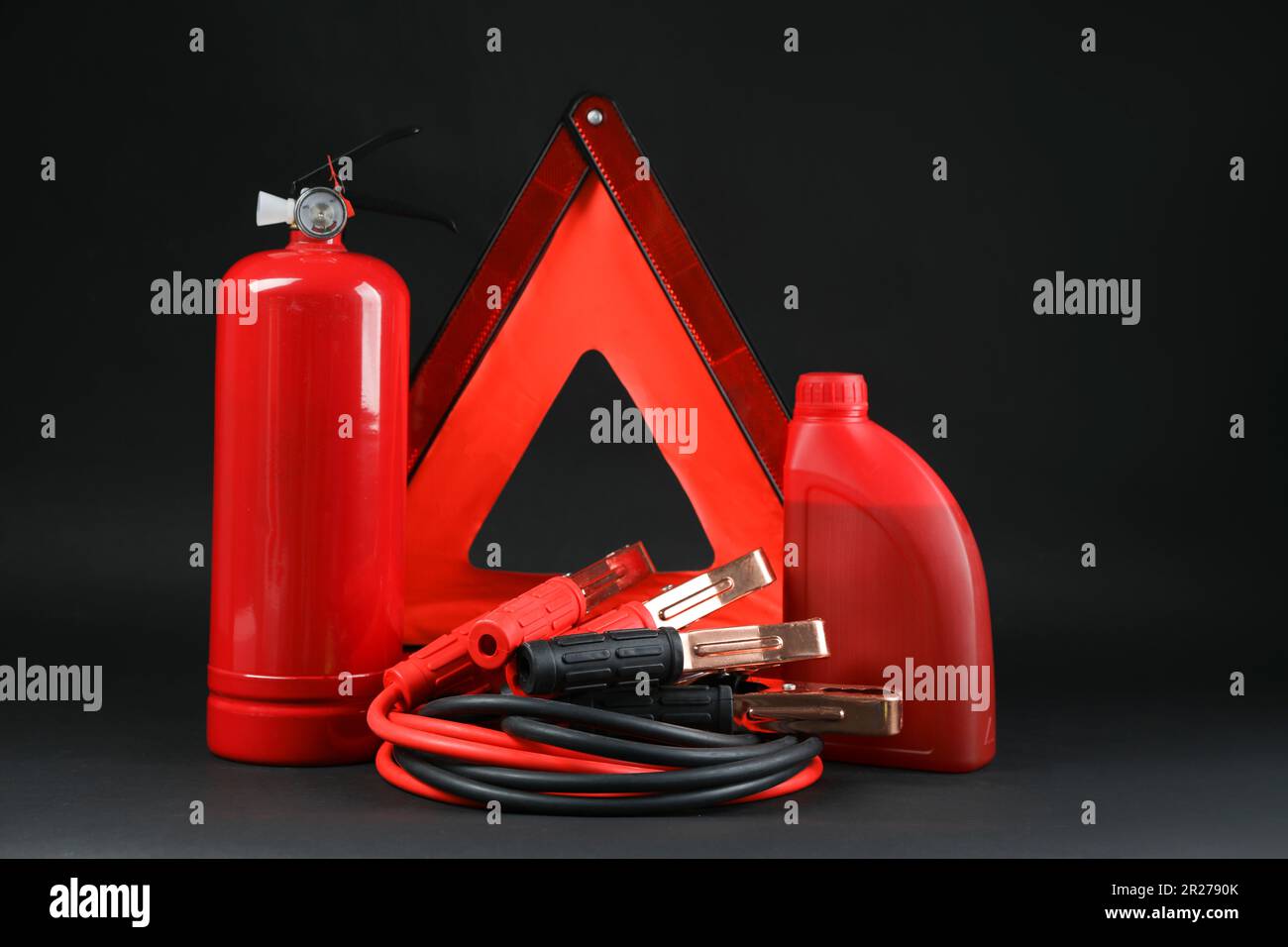 Emergency warning triangle, red fire extinguisher, battery jumper