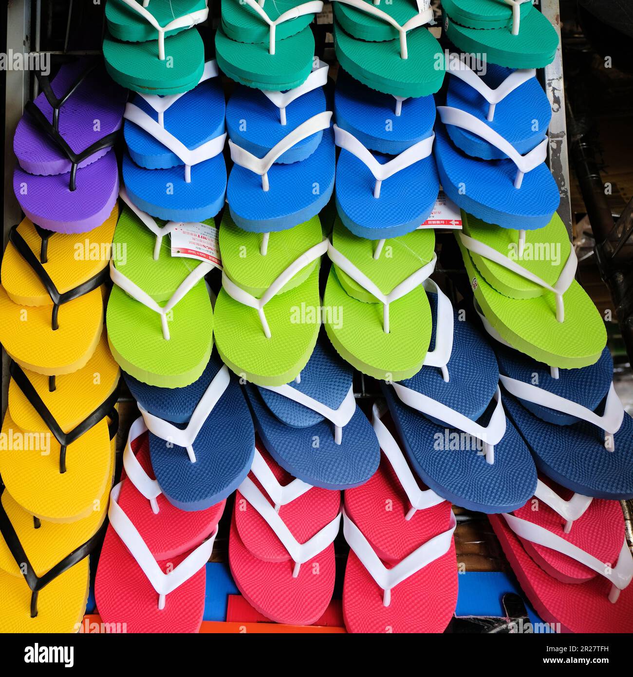 Rows of  many colorful flip flops for sale on the Island of Xiaoliuqiu in Taiwan, ROC; comfortable beachwear or footwear. Stock Photo
