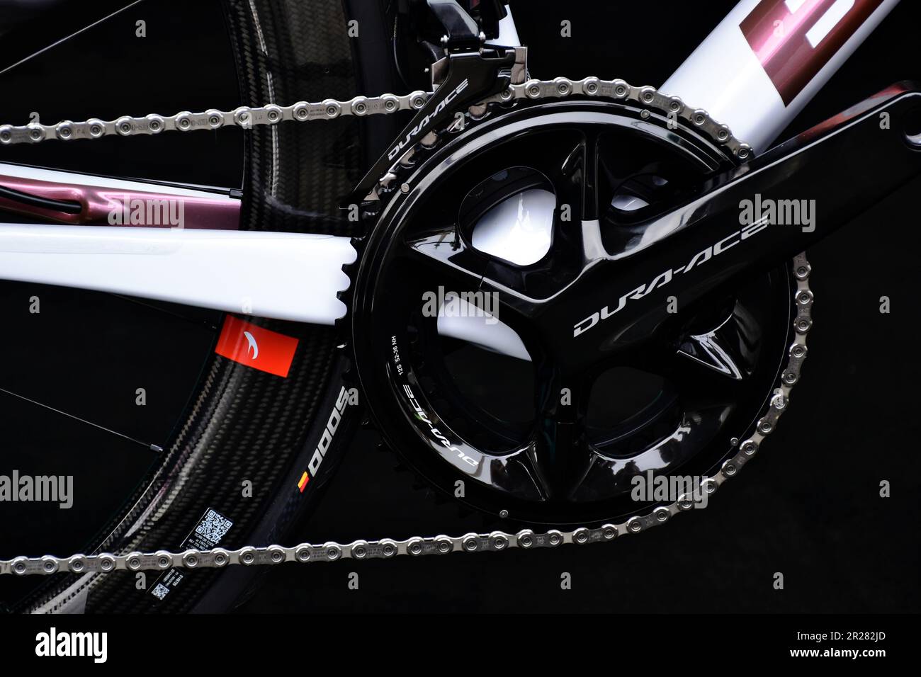 Shimano Dura-Ace front gear and drive crank race bike closeup. gearwheel, frame, composite wheel, rubber tire and spokes. high tech mechanical design Stock Photo