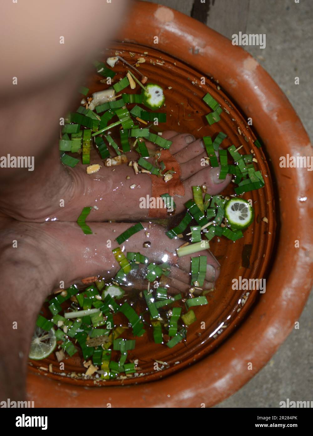 Soaking feet in hot herbal water before a Thai foot massage. Koh Kret
