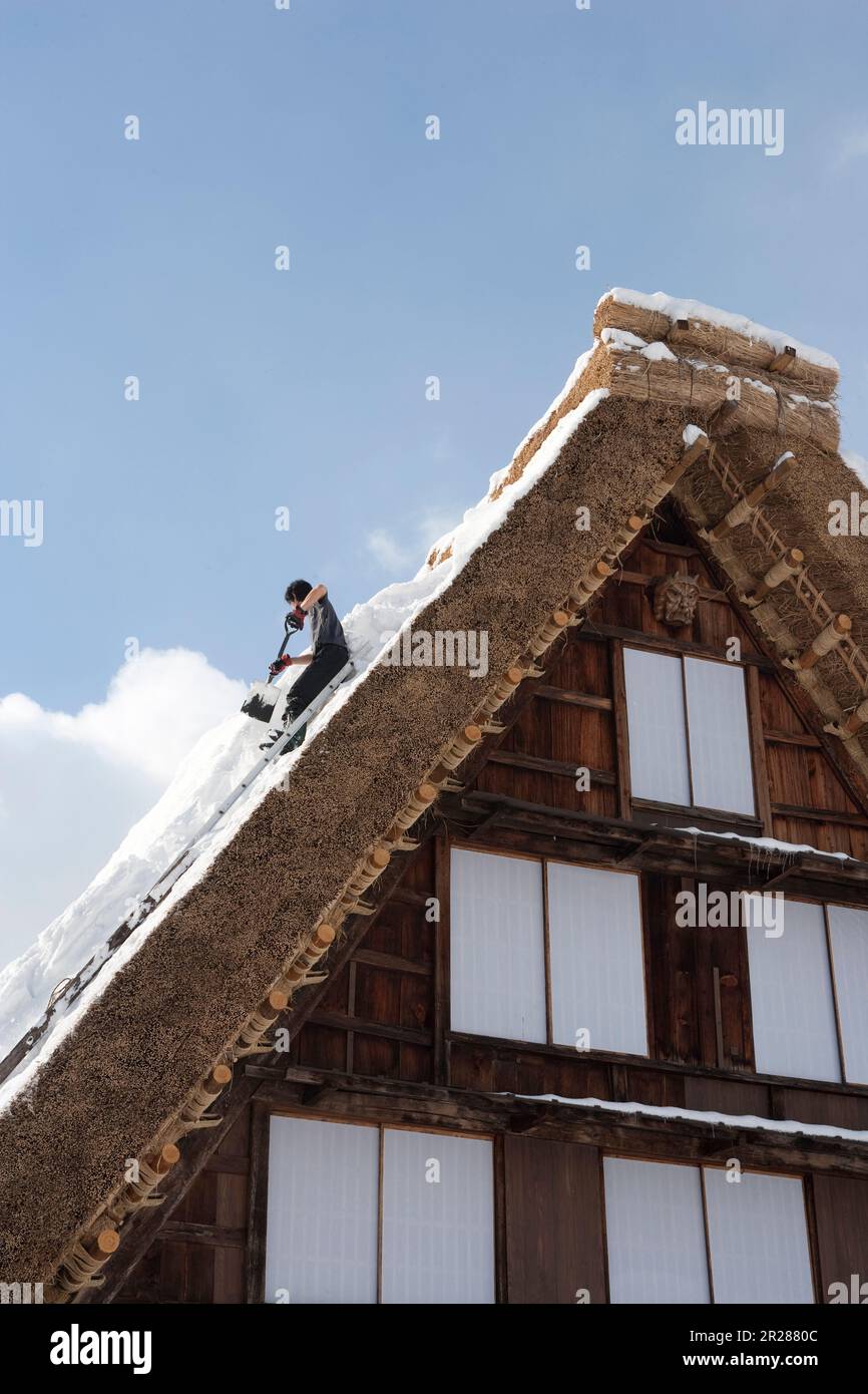 Snow clearing from the roof in Shirakawago Gasshozukuri Village in