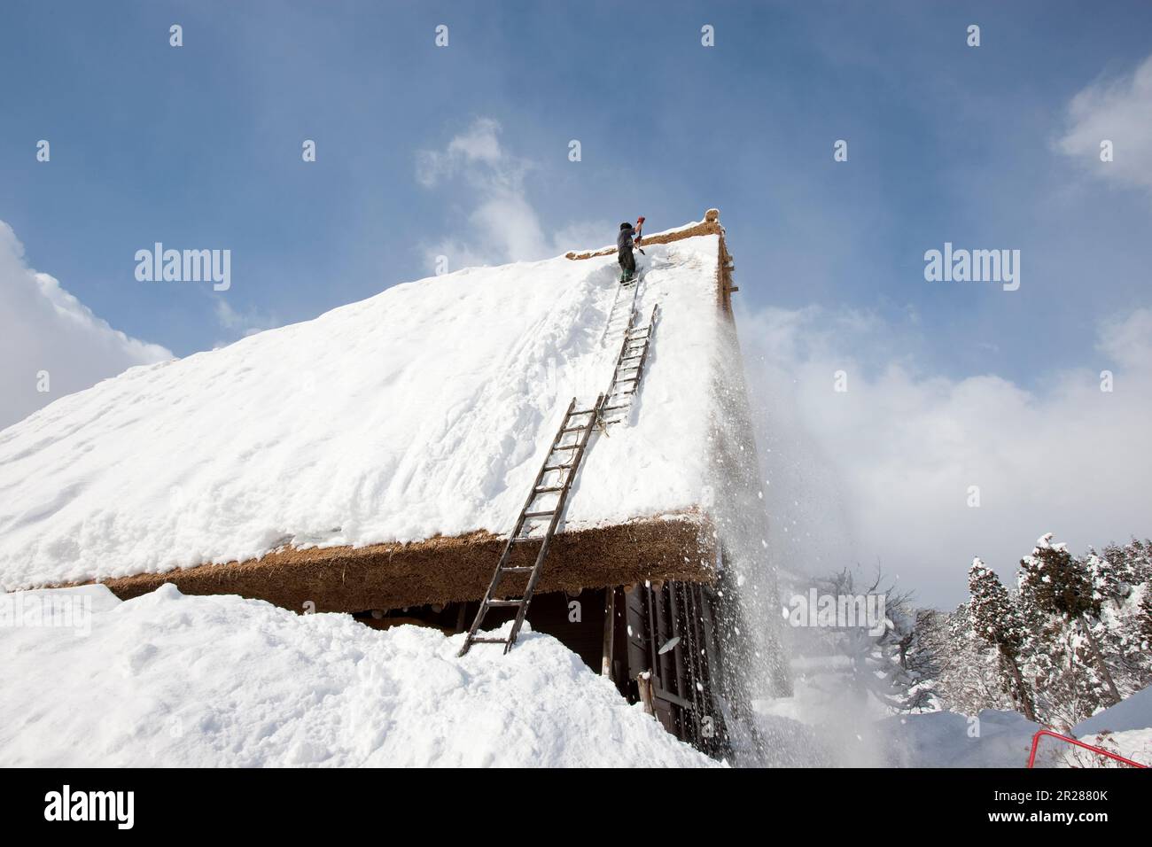 Snow clearing from the roof in Shirakawago Gasshozukuri Village in