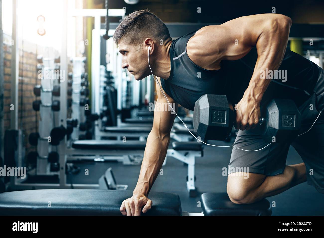 Difficult doesnt mean impossible. a man doing weight training at the gym. Stock Photo