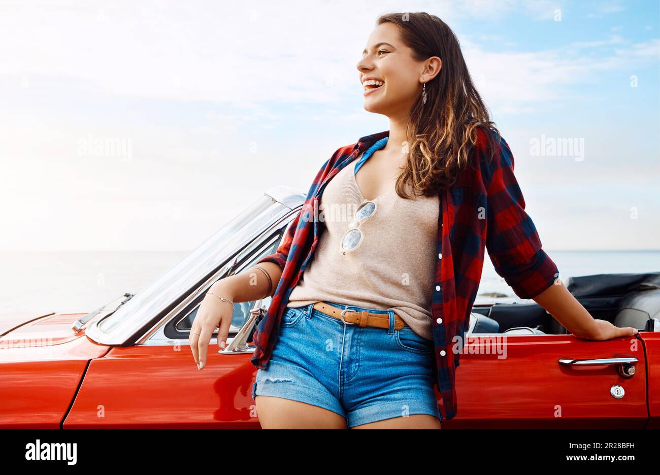 On the trip of a lifetime. a happy young woman enjoying a summers road ...