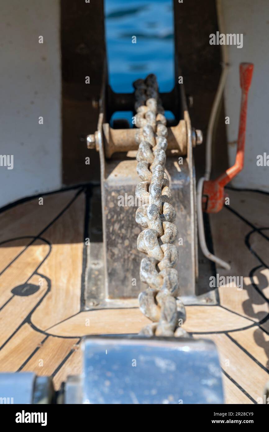 Close up view of an anchor chain from anchor winch on a sunny day. Stock Photo