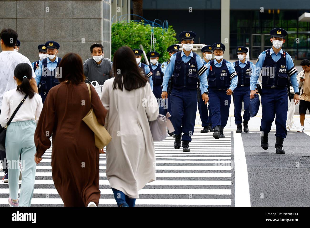 May 18, 2023, Hiroshima, Japan: Police officers patrol the streets near the International Media Center and other venues a day before the G7 Hiroshima Meeting kicks off. The annual G7 meeting gathers the leaders of countries (France, the United States, the United Kingdom, Germany, Japan, Italy, and Canada) as well as the European Union (EU) to discuss important challenges the international community is facing, such as the global economy, regional affairs, and other issues. Small groups of people against the G7 Summit protested near the world leaders meeting venues. (Credit Image: © Rodrigo Reye Stock Photo