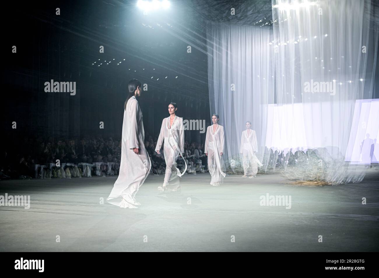 An in-camera multiple exposures of models walking the runway at the ...