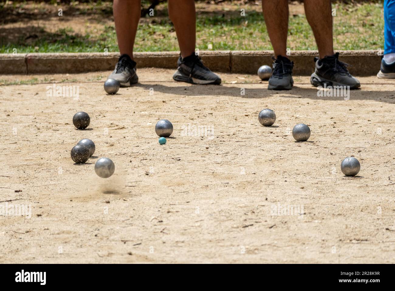 Metal ball from the game of petanque approaching the bowling alley