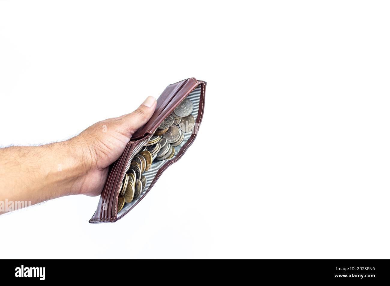 Men's wallet full with coins holding in hand isolated on white background Stock Photo
