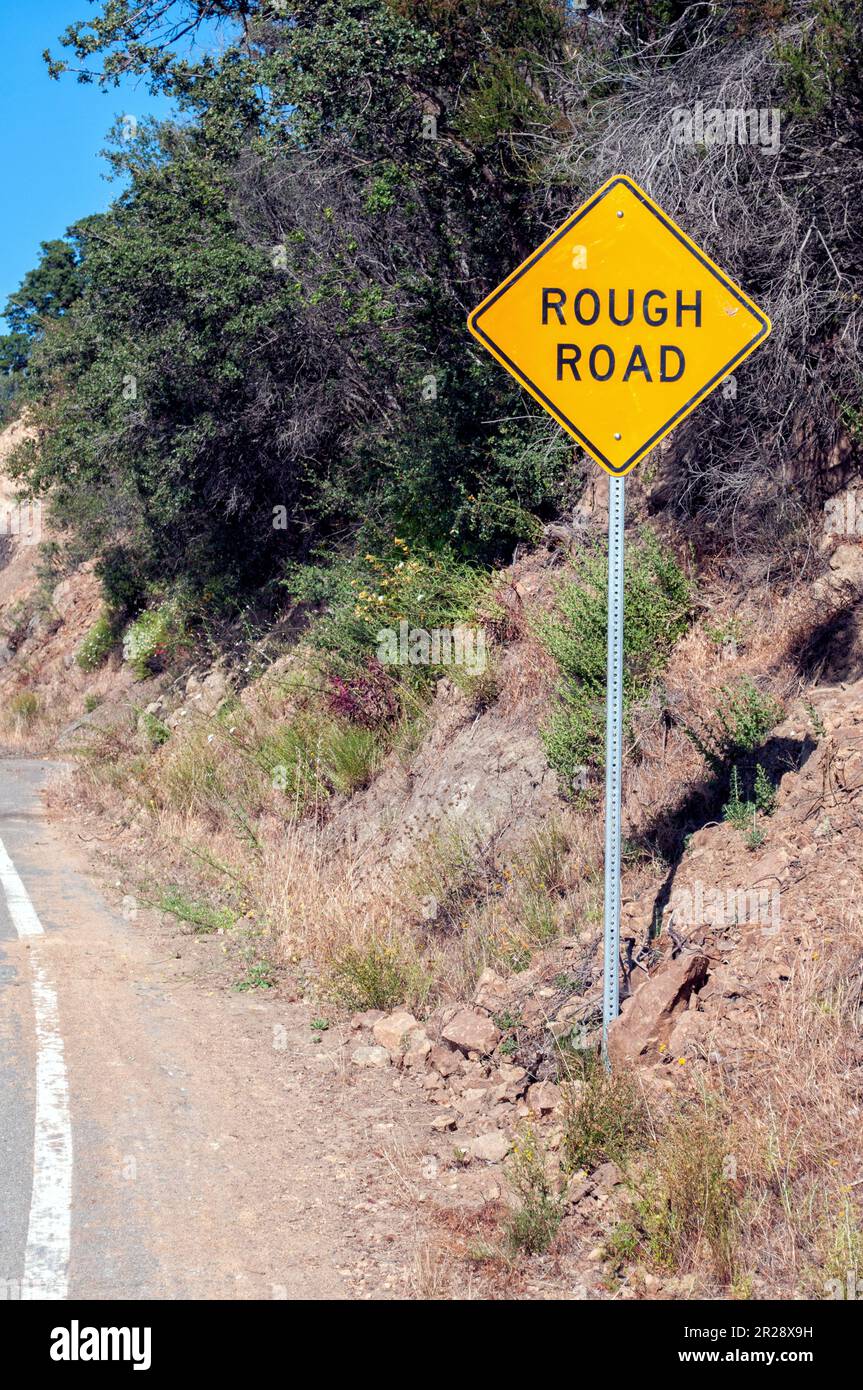 Rough road sign Stock Photo