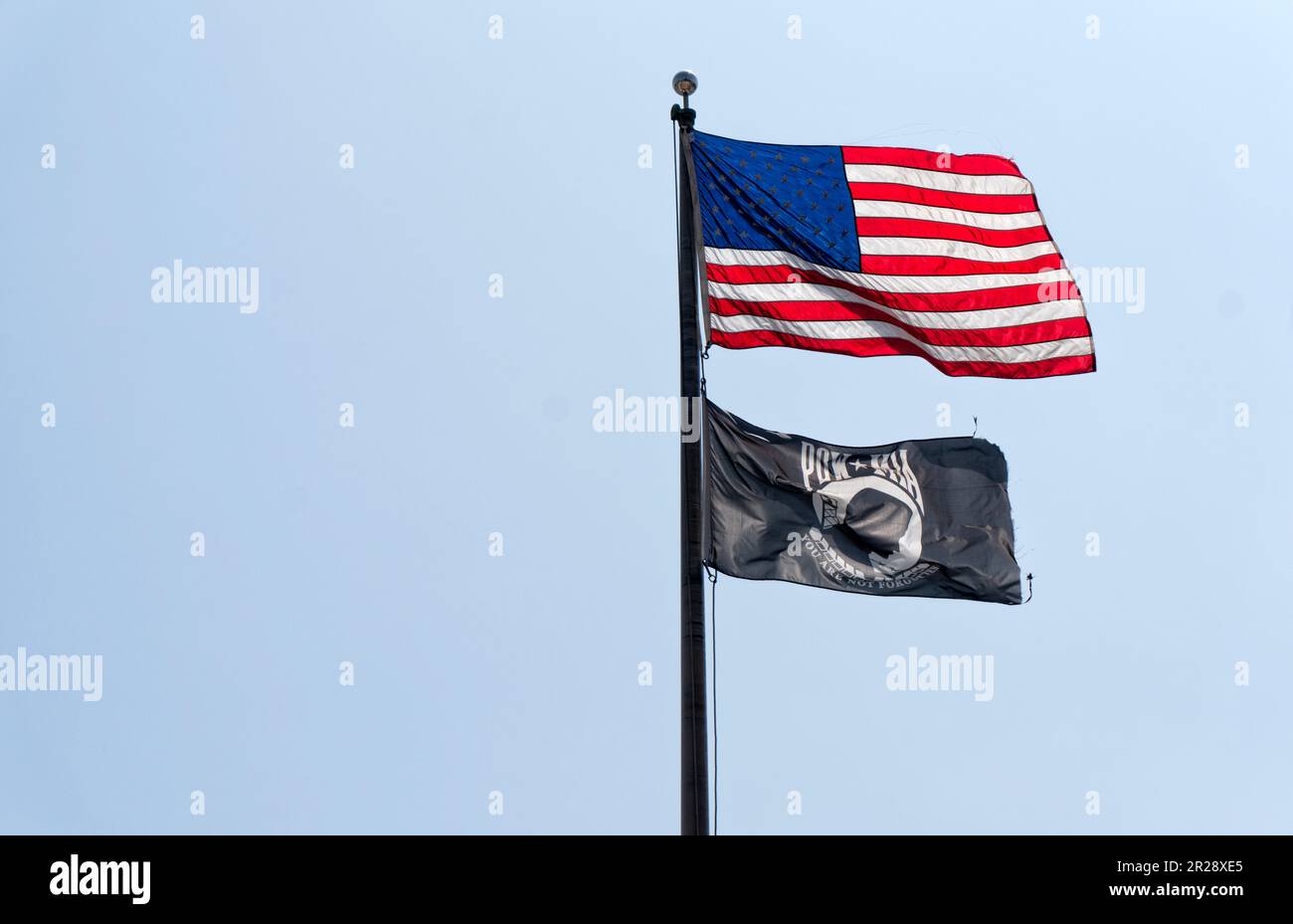 BURBANK, CA, USA – APRIL 4 2018: USA flag and POW-MIA flag on the flagpole Stock Photo