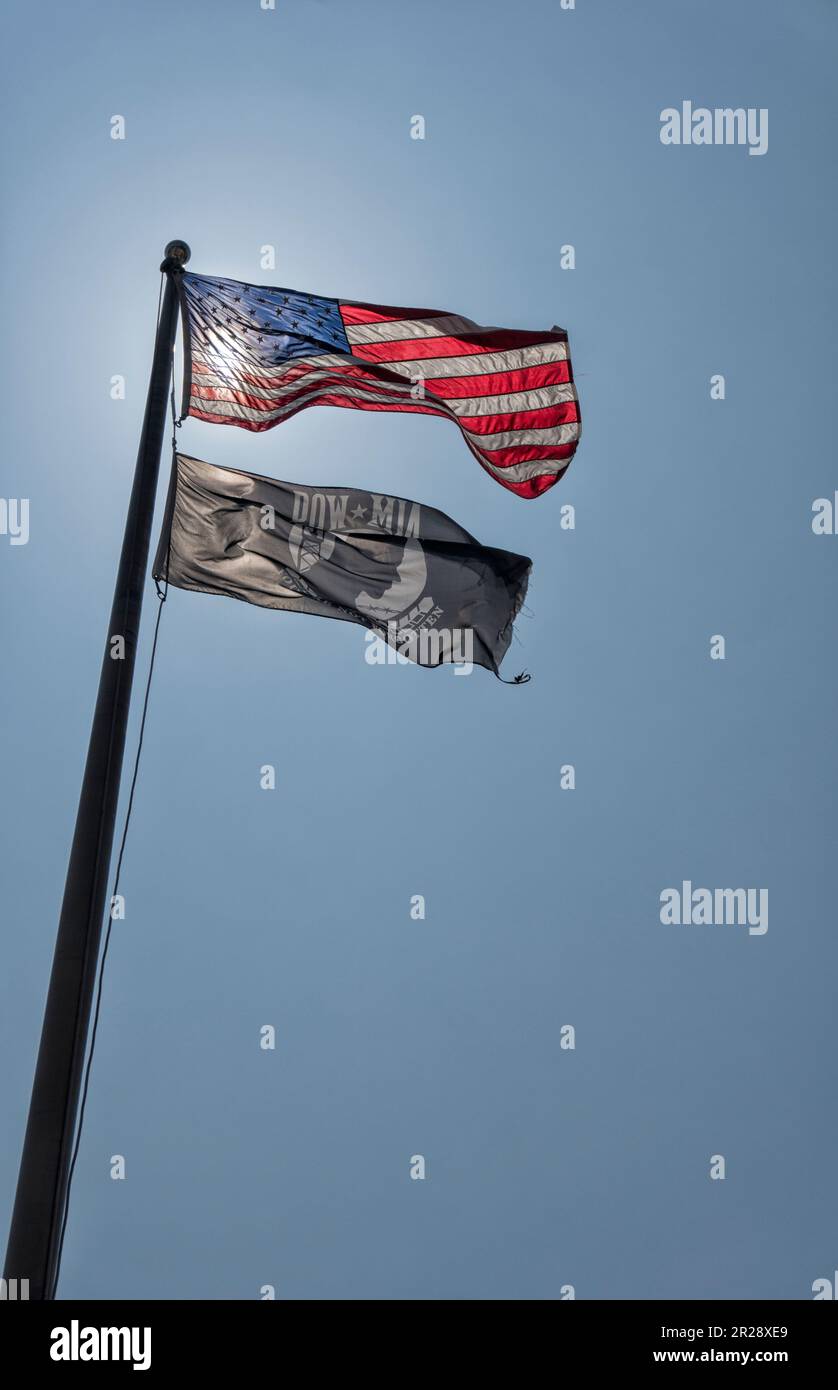 BURBANK, CA, USA – APRIL 4 2018: Low angle view of USA and Pow-Mia flag against blue sky on sunny day Stock Photo