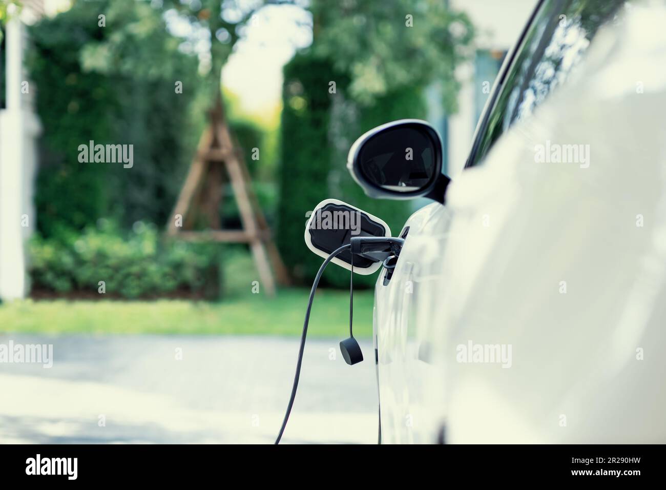 Closeup electric vehicle pluggedin with cable from charging point