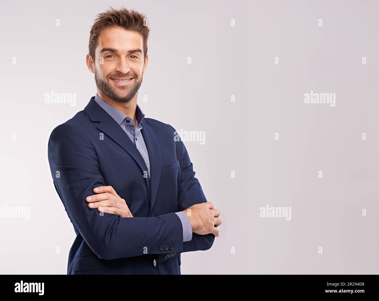 Portrait of confident business man, arms crossed in a suit with smile ...