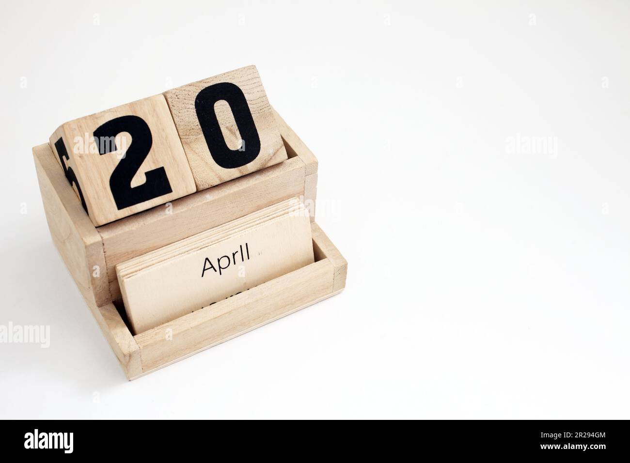 Wooden perpetual calendar showing the 20th of April Stock Photo - Alamy