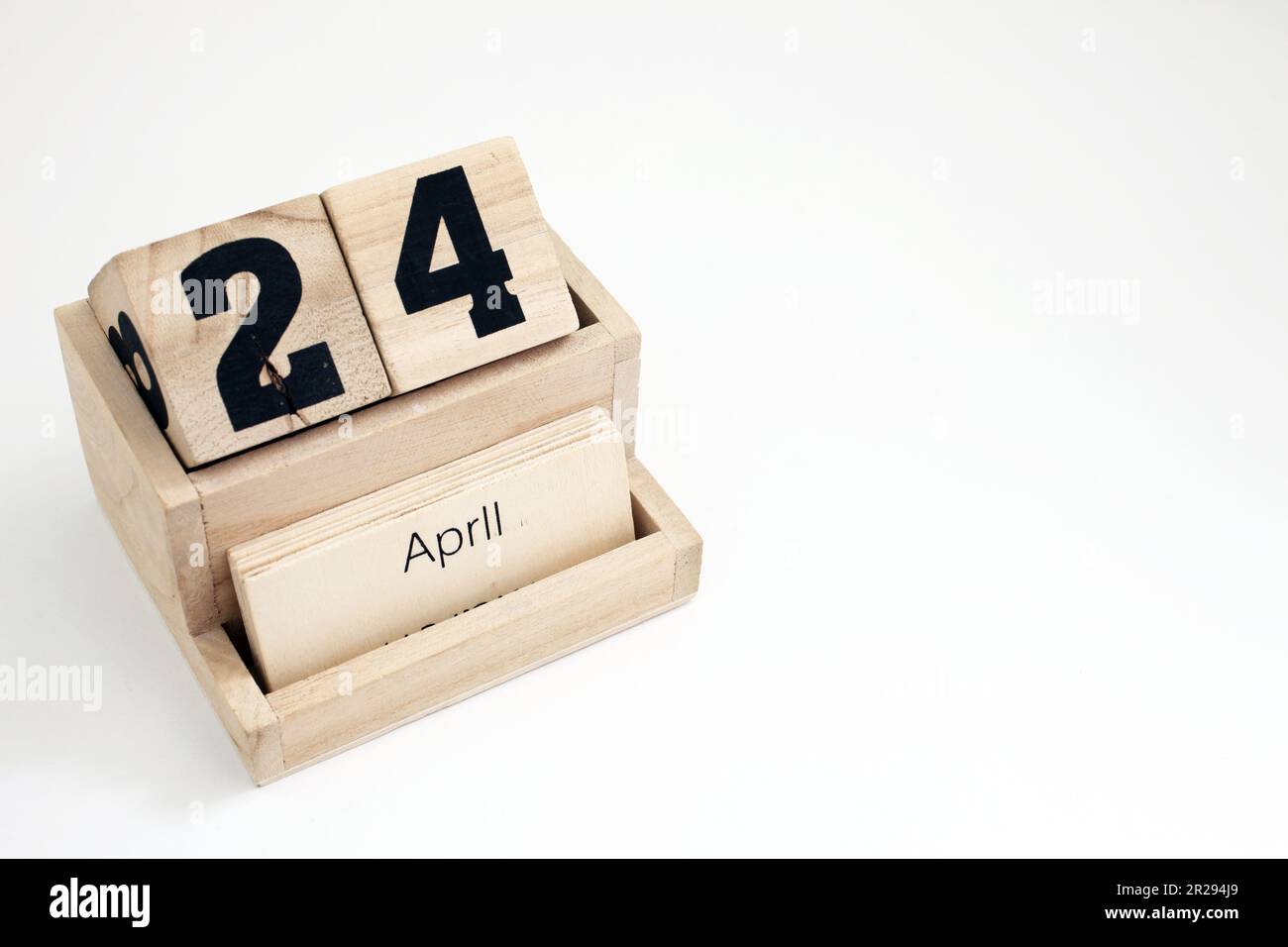 Wooden perpetual calendar showing the 24th of April Stock Photo - Alamy
