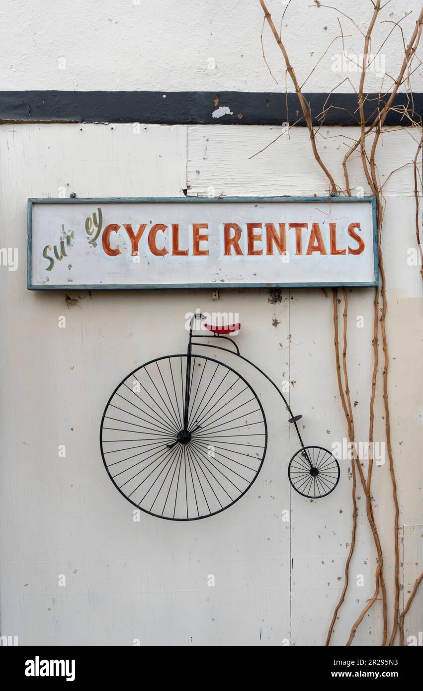 Cycle rentals sign with high wheel bicycle Stock Photo Alamy