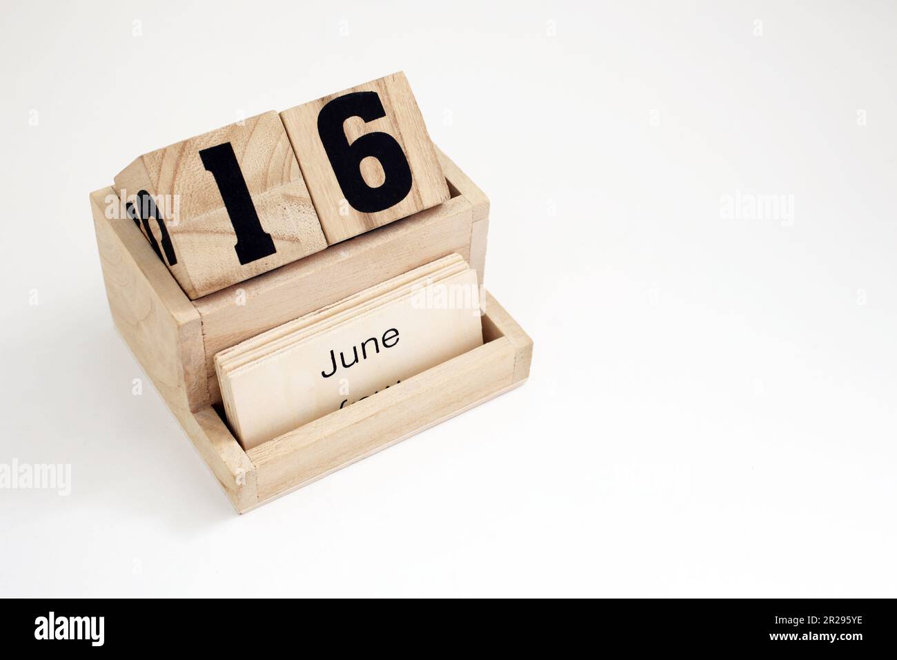 Wooden perpetual calendar showing the 16th of June Stock Photo Alamy
