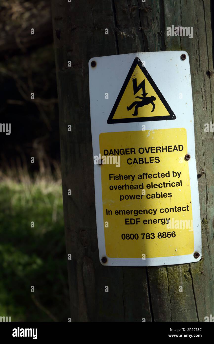 Danger overhead Cables at Fishery on River Wey Navigations Surrey England Stock Photo